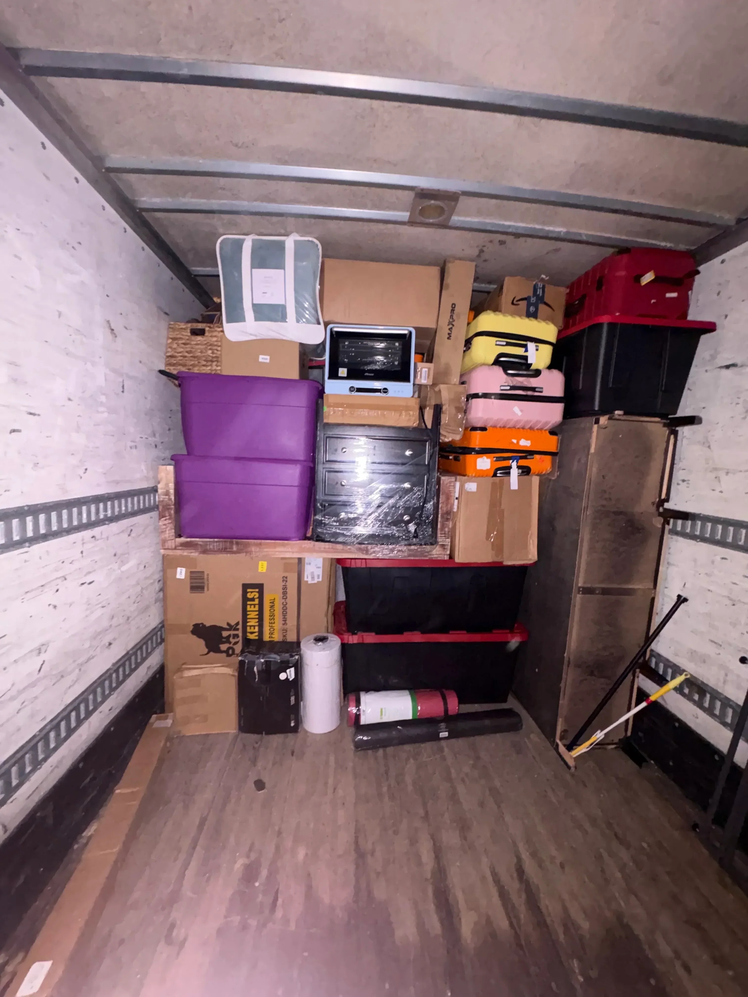 Interior of moving truck with organized boxes, furniture, and household items ready for transport