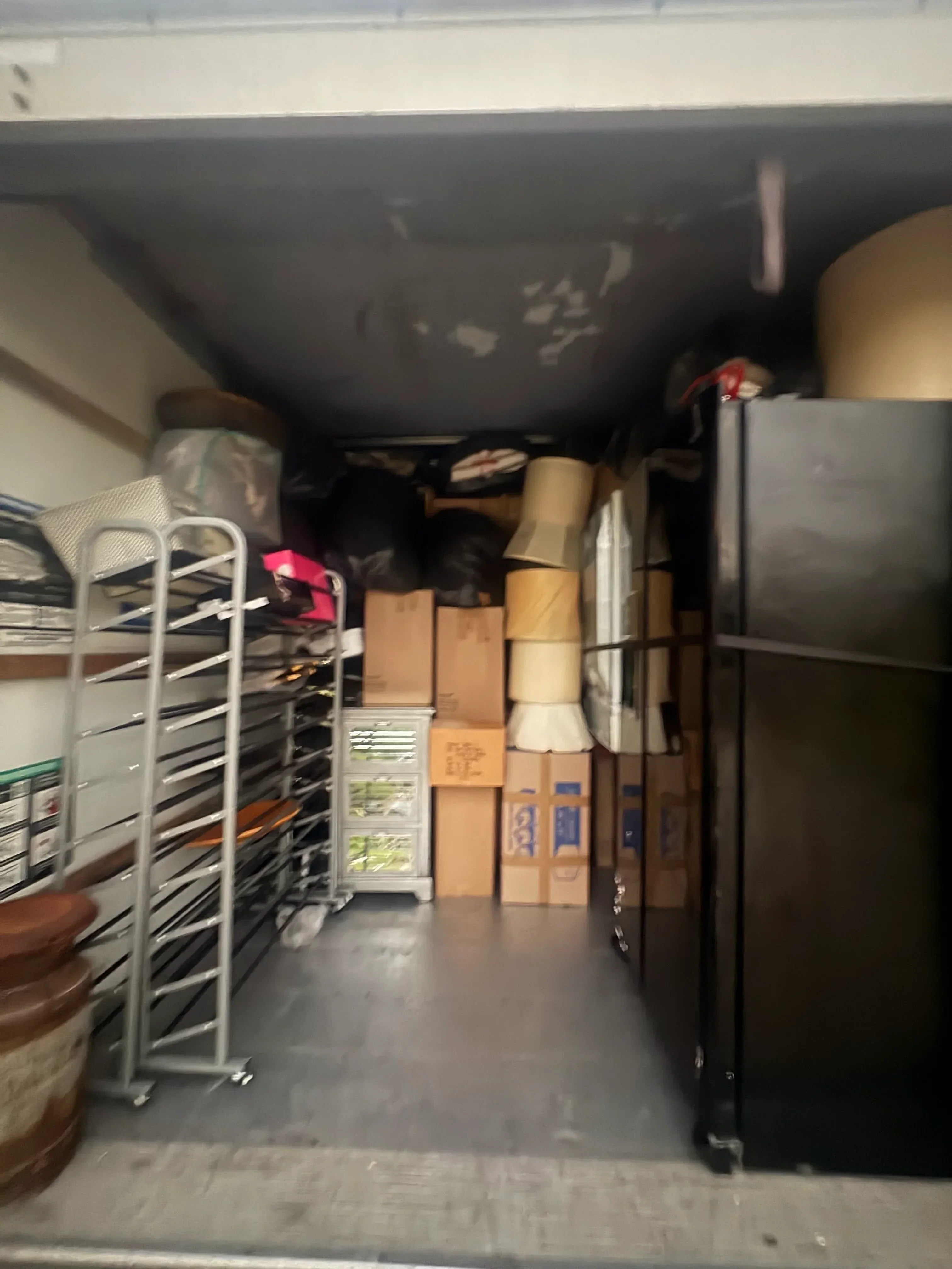 Moving truck interior packed with organized boxes, wrapped furniture, and secured household goods